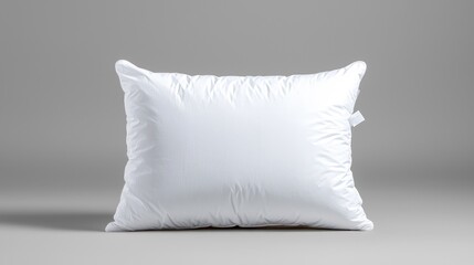 White pillow on grey background; restful sleep product shot