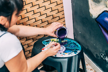 Hands Of An Female Artist Preparing Colors On A Palette For A Masterpiece - The Art Of Graphic...