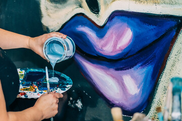 Professional Painter Pouring Blue Paint Onto A Palette In A Vibrant Studio - The Art Of Graphic...