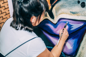 Creative Woman Painting A Stunning Contemporary Artwork On Huge Canvas Inside An Artistic Studio