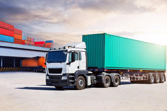 Semi Trailer Trucks on The Parking Lot at Warehouse Port. Trucks Loading Goods at Dock Warehouse. Distribution Warehouse Center. Containers Shipping. Freight Truck Logistics, Cargo Transportation.