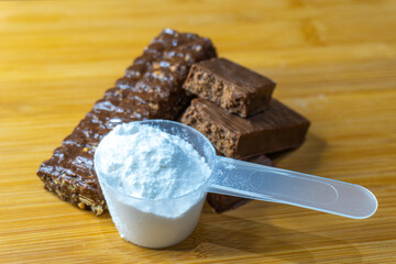 Protein bar cut on the table one protein scoop