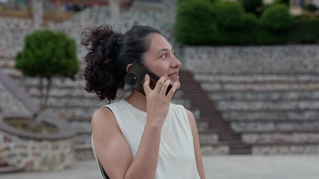 hispanic young woman talking on cell phone