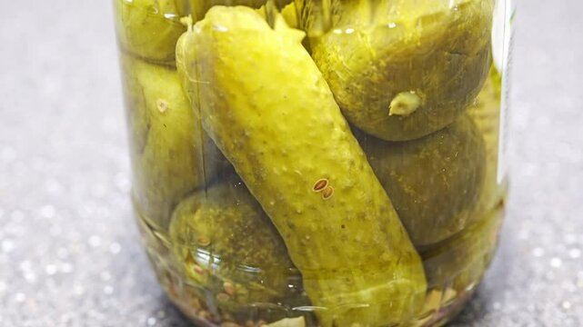 a jar of pickled cucumbers. containers for canned vegetables.