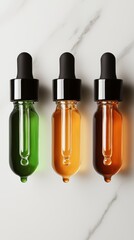 Obraz premium Three glass droppers releasing golden, green, and bronze serum droplets, glowing softly with a luxurious skincare aesthetic.