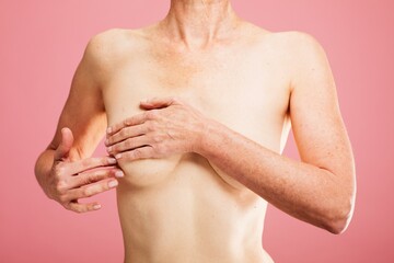 Mature woman breast cancer self check. Mature woman doing doing a breast self exam checking up....