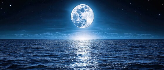 Full moon over dark ocean with stars and clouds in the night sky creating a serene scene