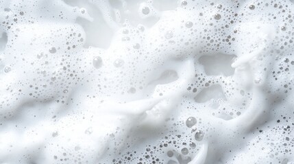 Close up of white liquid with bubbles and calm transparent water in a clear and detailed view