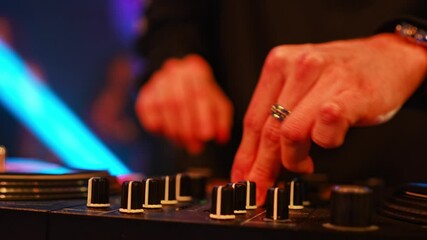Hands of a DJ with a mixing console at a party. music for the disco. Professional musician.