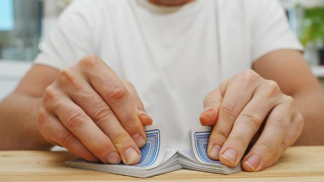 male hands shuffle a deck of playing cards. gambling. A board game for spending leisure time with friends and family.
