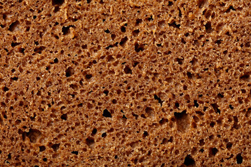 The image is of a brown bread with holes in it