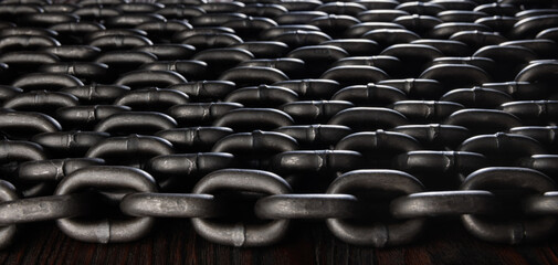 Heavy iron chain. Background of several evenly laid out iron chains.