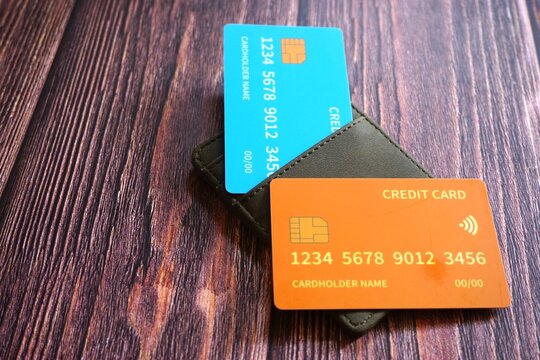 Credit card and holder on a wooden table.