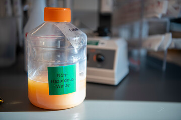 Non-hazardous waste orange liquid gallon plastic jug science lab