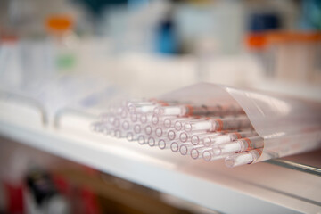 extended length pipette tips laying on biotech science lab shelf