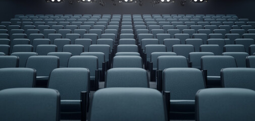 Fototapeta premium Empty theater seating arranged in neat rows under dim lighting.
