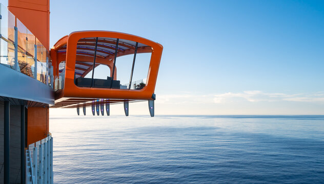 Grand Cayman, Cayman Islands - Nov 22, 2024: Cruise ship Celebrity Ascent Magic Carpet, orange floating platform above the Caribbean Sea.