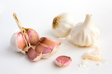 Garlic heads and cloves on white background