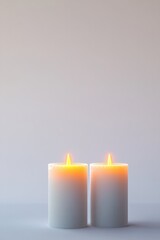 Two softly glowing candles create serene atmosphere against mini