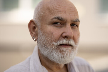 Old man with Grey hair and white beard. Bearded Senior man. Face of bearded senior age man. Headshot of bald pensioner, retiree concept. Closeup portrait of an old mature senior man with grey beard.