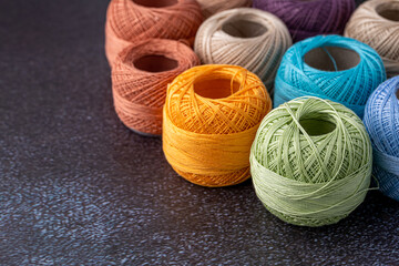 Multicolor yarn for knitting, knitting needles and scissors. Home storage concept and hobby.Raffia is an organic, ecological, wood fiber that is easy to crochet.