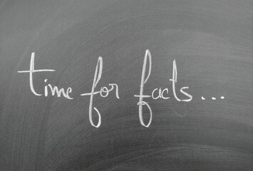 Time for facts written on a blackboard in chalk handwriting