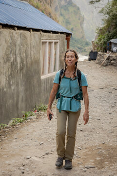 Female walks through small Nepalese village