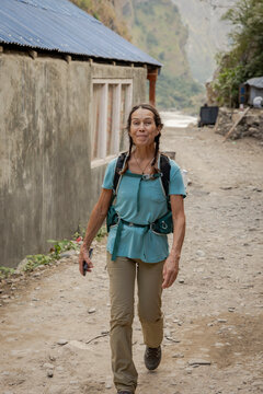 Female walks through small Nepalese village