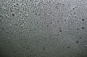 Stright view of water droplets with dark background suitable for wallpaper