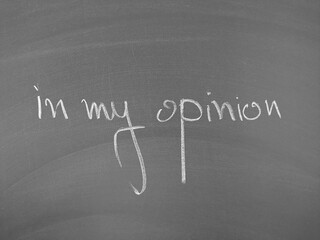 in my opinion written in chalk on a blackboard surface