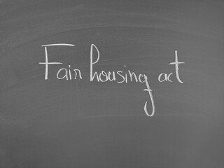 Chalkboard displaying the words 'fair housing act' written in white chalk