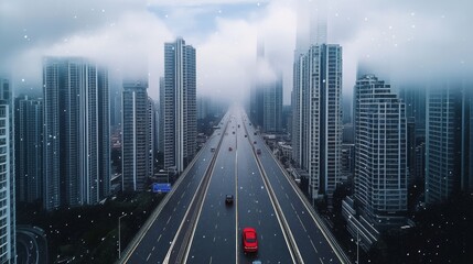 Red car is driving down a city street with tall buildings in the background. The sky is cloudy and the city appears to be covered in a light snow