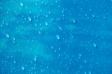 Top view of droplets with blue color background suitable for wallpaper