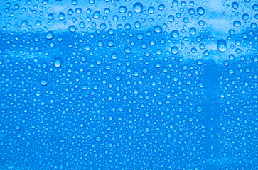 Top view of water droplets with blue color background suitable for wallpaper.