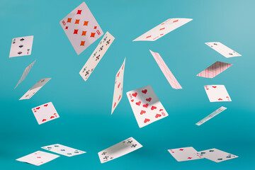 flying playing cards on a turquoise background