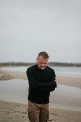 Contemplative Man Walking on a Beach