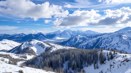 Panoramic view of snow-covered mountain ranges under a bright winter sky, showcasing majestic peaks and evergreen forests.