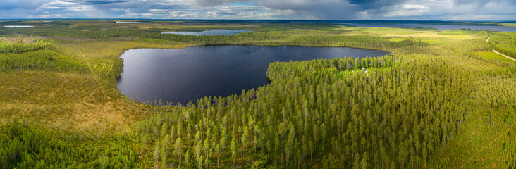 Aerial view over boreal forest with lakes in central Finland