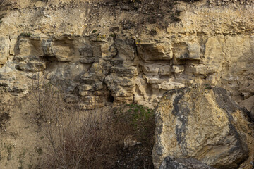 Rock formations on a rugged hillside showcasing natural geological patterns and textures
