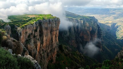 Dramatic cliffs and misty valleys capture the wild beauty of a mountain landscape