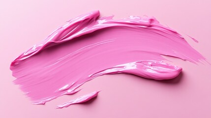A pink brush stroke on a pink background. The brush stroke is very thick and has a lot of paint on it