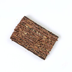 A delectable oat bar features a chocolate layer topped with zigzagged chocolate drizzle, showcasing a crunchy yet rich texture