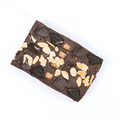 Savor the rich brownie with a decadent topping of sliced almonds and cookie pieces, ideal for indulgent dessert occasions