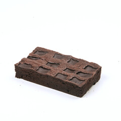 A rich chocolate brownie sits on a clean white surface, showcasing its dense texture and glossy top, perfect for dessert lovers