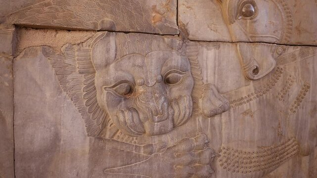 The walls of Persepolis in Iran are decorated with beautiful bas-reliefs that represent a symbol of Zoroastrianism, the eternal struggle between a bull and a lion. UNESCO World Heritage Site