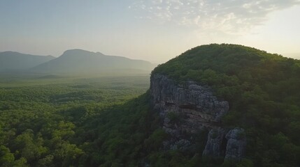 Fototapeta premium Majestic Mountaintop at Sunrise: An Aerial View of Serene Landscape