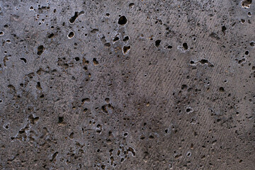 Dark gray porous concrete close-up, texture and background.