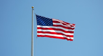 Obraz premium American Flag Waving Against Blue Sky