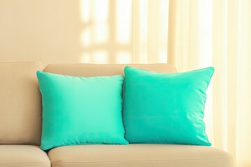 close-up photo of sleek neutral sofa with bold turquoise cushions under soft ambient lighting in spacious interior