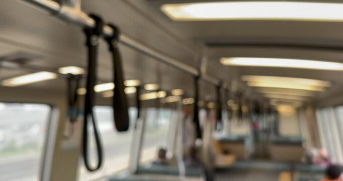 Defocused view of the interior of a train car belonging to a local public transit system.